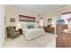 Spacious bedroom with a king-size bed, dresser, and seating area at 120 Grand Oak Cir, Venice, FL 34292