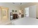 King-size bed, ensuite bathroom, and views into other rooms at 120 Grand Oak Cir, Venice, FL 34292