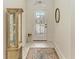 Bright entryway with tile floors, a decorative rug, and a display cabinet at 120 Grand Oak Cir, Venice, FL 34292