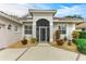 Front entry featuring a screened door and well-maintained landscaping at 120 Grand Oak Cir, Venice, FL 34292