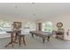 Community game room with pool table and seating area at 120 Grand Oak Cir, Venice, FL 34292
