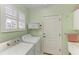 Convenient laundry room with washer, dryer, and storage cabinet at 120 Grand Oak Cir, Venice, FL 34292