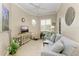 Bright living room features comfy seating, large TV, and hardwood floors at 120 Grand Oak Cir, Venice, FL 34292