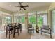 Bright sunroom with seating area and view of backyard at 120 Grand Oak Cir, Venice, FL 34292