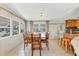 Bright dining area with wood table and chairs, adjacent to kitchen at 1211 45Th E Ave, Ellenton, FL 34222