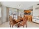 Bright dining area with wood table and chairs, adjacent to kitchen at 1211 45Th E Ave, Ellenton, FL 34222