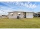 Side view of tan mobile home with grassy yard at 1211 45Th E Ave, Ellenton, FL 34222