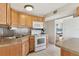 Galley kitchen with oak cabinets and white appliances at 1211 45Th E Ave, Ellenton, FL 34222