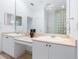 Double vanity bathroom with large mirror and glass block shower at 12317 Baypointe Ter, Cortez, FL 34215