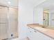 Bathroom with shower and vanity with beige countertop at 12317 Baypointe Ter, Cortez, FL 34215