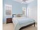 Light blue bedroom with double bed, nightstand, and built-in closet at 12317 Baypointe Ter, Cortez, FL 34215