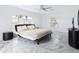 Primary bedroom with marble floors, large windows and ceiling fan at 12317 Baypointe Ter, Cortez, FL 34215