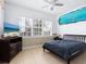 Bedroom with ocean mural, TV, and comfortable bed at 12317 Baypointe Ter, Cortez, FL 34215