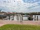 Community boat docks on calm waters with homes in the background at 12317 Baypointe Ter, Cortez, FL 34215