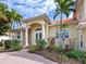 House entrance with columns and lush landscaping at 12317 Baypointe Ter, Cortez, FL 34215
