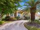 Stunning home with palm trees and a brick driveway at 12317 Baypointe Ter, Cortez, FL 34215