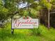 Entrance sign for Geraldson Community Farm, nestled in a verdant natural setting at 12317 Baypointe Ter, Cortez, FL 34215