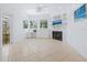 Gathering room features built-in shelving, fireplace, and access to outdoor space at 12317 Baypointe Ter, Cortez, FL 34215