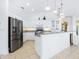 White kitchen with stainless steel appliances and granite countertops at 12317 Baypointe Ter, Cortez, FL 34215