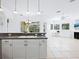 Kitchen island with sink and granite countertop, overlooking the Gathering room at 12317 Baypointe Ter, Cortez, FL 34215