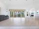 Spacious living room with sliding glass doors to lanai and pool at 12317 Baypointe Ter, Cortez, FL 34215