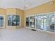 Covered patio with tile floors, ceiling fan, and sliding glass doors at 12317 Baypointe Ter, Cortez, FL 34215