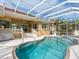 Inviting pool area with a large pool and spa, screened enclosure, and patio at 12317 Baypointe Ter, Cortez, FL 34215