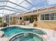 Relax in your own backyard oasis, complete with a pool, spa, and screened enclosure at 12317 Baypointe Ter, Cortez, FL 34215