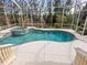Relaxing freeform swimming pool with spa and screened enclosure at 12317 Baypointe Ter, Cortez, FL 34215