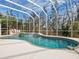 Enjoy this refreshing freeform swimming pool and spa with a screened enclosure at 12317 Baypointe Ter, Cortez, FL 34215
