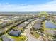 Aerial view of house and community amenities, including a lake at 12556 Ryegrass Loop, Parrish, FL 34219