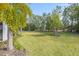 Spacious backyard with mature trees and a grassy area at 12556 Ryegrass Loop, Parrish, FL 34219