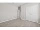 Well-lit bedroom with double doors and wood-look floors at 12556 Ryegrass Loop, Parrish, FL 34219