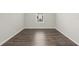 Simple bedroom with wood-look floors and a window at 12556 Ryegrass Loop, Parrish, FL 34219