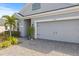 House exterior showing garage and landscaping at 12556 Ryegrass Loop, Parrish, FL 34219