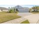 House exterior with a large yard and a paved driveway at 12556 Ryegrass Loop, Parrish, FL 34219