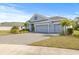 Two-story house with a three-car garage, landscaping, and paved driveway at 12556 Ryegrass Loop, Parrish, FL 34219