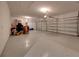 Two-car garage with epoxy flooring and ample storage space at 12556 Ryegrass Loop, Parrish, FL 34219