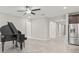 Open living space with tile floors and a grand piano at 12556 Ryegrass Loop, Parrish, FL 34219