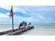 Beachfront view with American and military flags at 145 Avenida Messina # 3, Sarasota, FL 34242