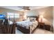 Spacious bedroom with ceiling fan, double nightstands, and leafy patterned bedding at 145 Avenida Messina # 3, Sarasota, FL 34242
