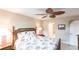 Relaxing bedroom with ceiling fan, double nightstands, and leafy patterned bedding at 145 Avenida Messina # 3, Sarasota, FL 34242
