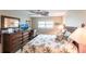 Bright bedroom with a dresser, desk and leafy patterned bedding at 145 Avenida Messina # 3, Sarasota, FL 34242