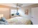 Cozy bedroom with ceiling fan, dresser, and cheerful bedding at 145 Avenida Messina # 3, Sarasota, FL 34242