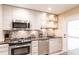 Modern kitchen with stainless steel appliances and a stylish backsplash at 145 Avenida Messina # 3, Sarasota, FL 34242