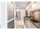 Modern kitchen with stainless steel appliances and a breakfast bar at 145 Avenida Messina # 3, Sarasota, FL 34242