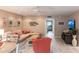 Bright living room with L-shaped sofa, coral chair, and access to other rooms at 145 Avenida Messina # 3, Sarasota, FL 34242