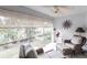 Bright sunroom with wicker furniture and serene views at 145 Avenida Messina # 3, Sarasota, FL 34242