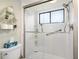 Clean bathroom with shower/tub combo, and decorative shelving at 1701 Pelican Cove Rd # 359, Sarasota, FL 34231