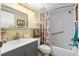 Bathroom with vanity, shower/tub combo, and coastal decor at 1701 Pelican Cove Rd # 359, Sarasota, FL 34231